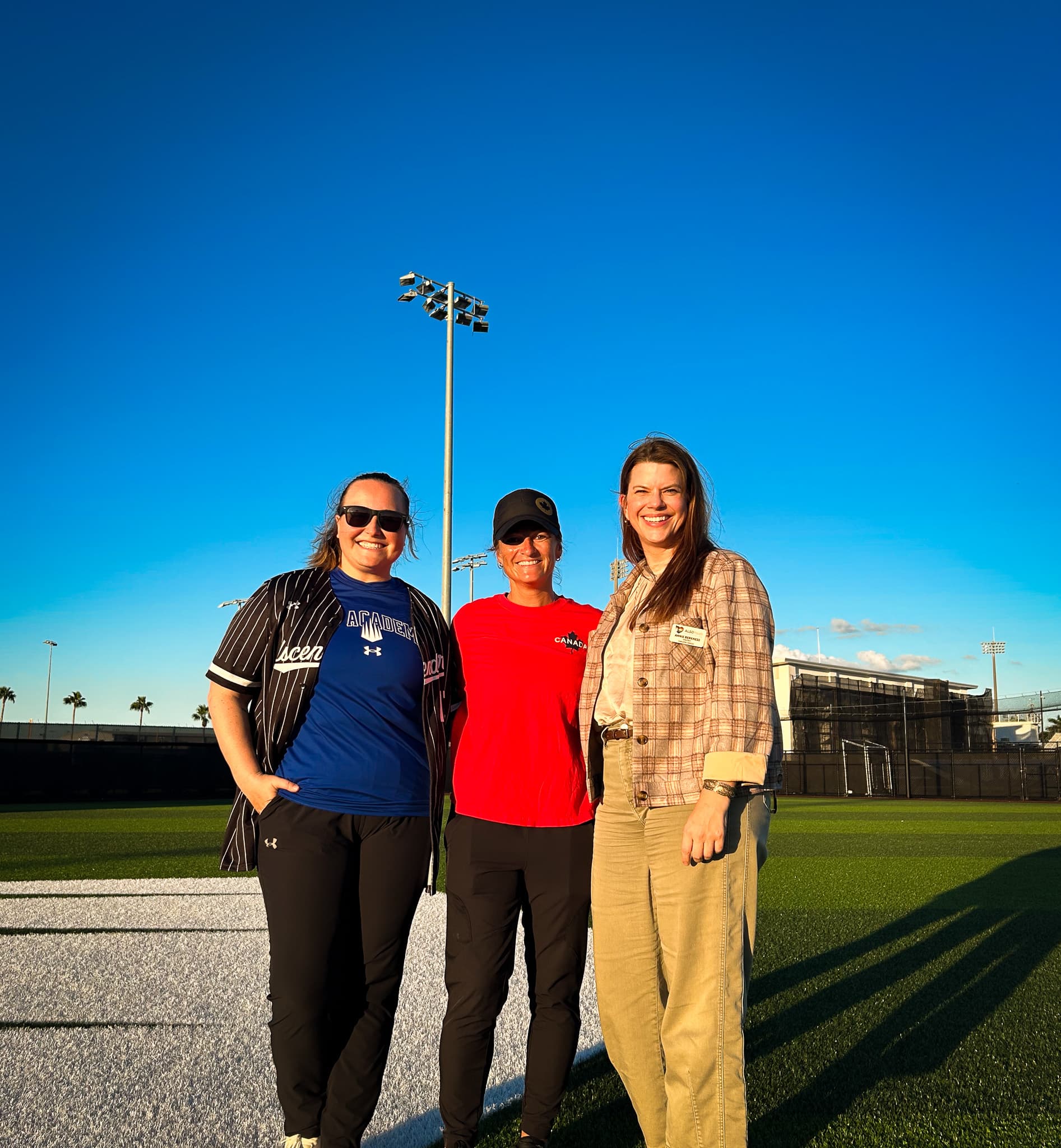 Executive Director Annie Berkness (far right) with IMG Softball Program Director (center) and IMG Foundation Executive Director Kate Massey (far left)