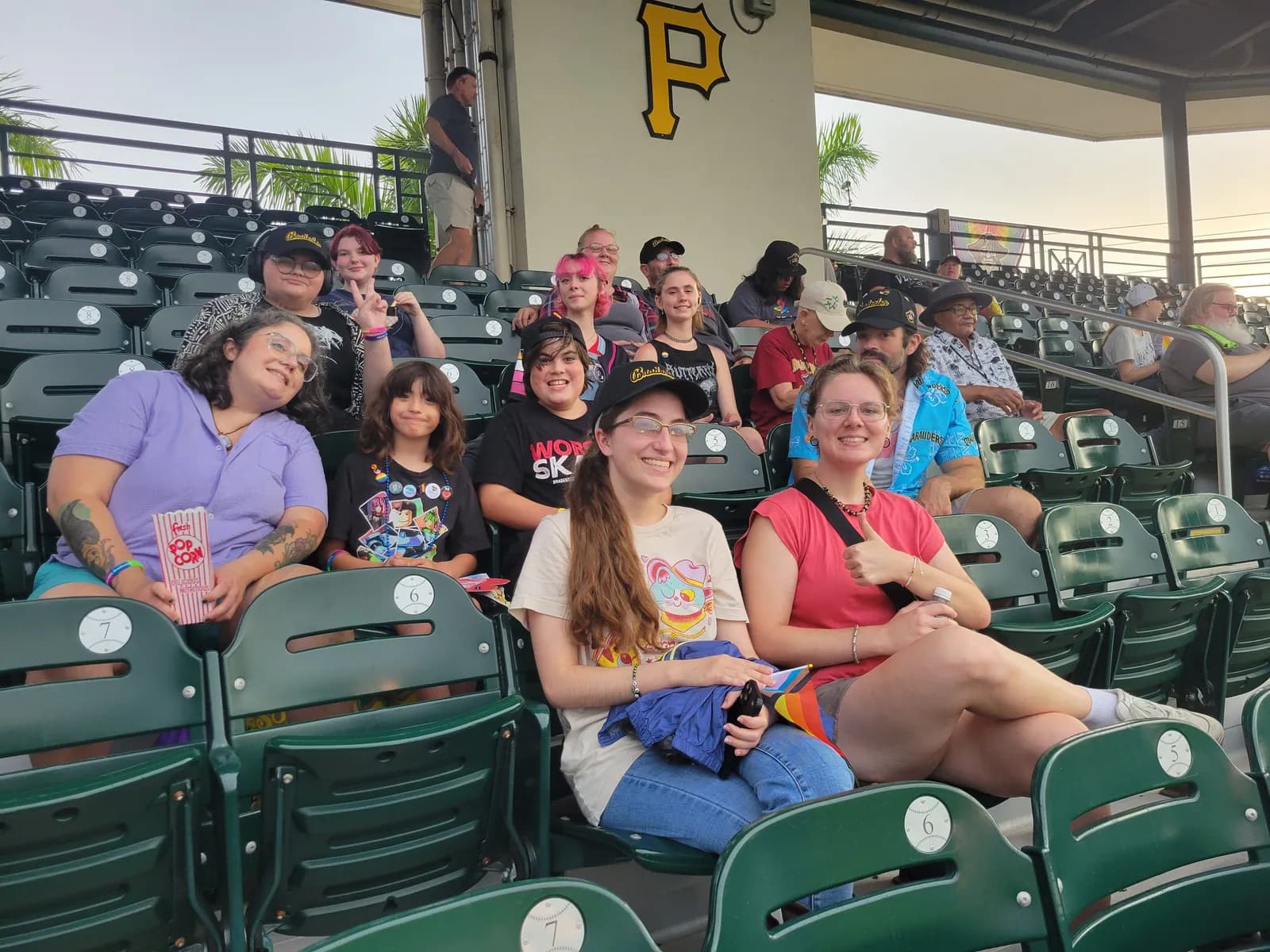 ALSO Youth members and friends filling a few rows of green stadium seats.