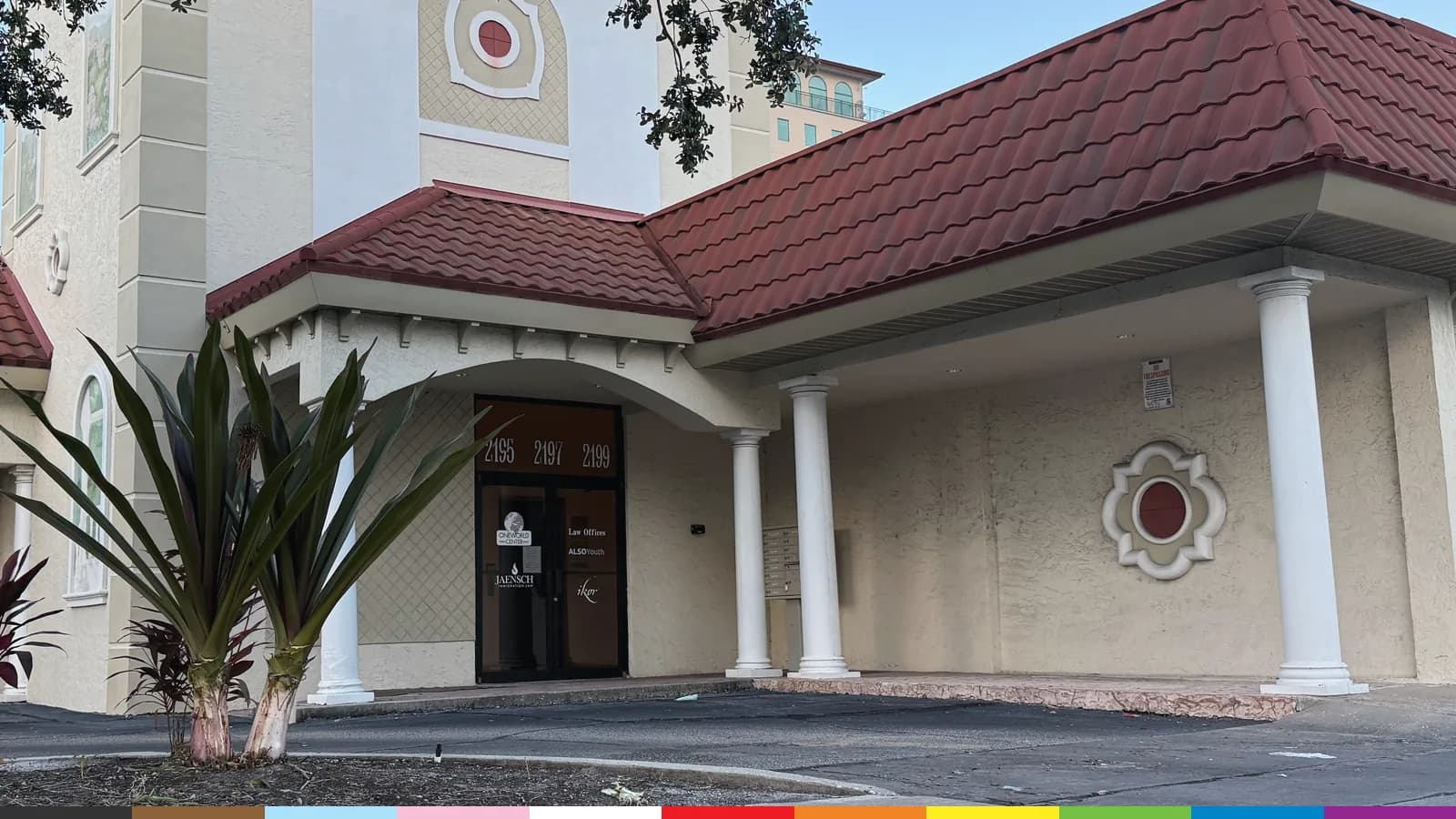 The entrance of ALSO Youth's Sarasota Center on Ringling Boulevard: white columns, arched windows, and a red tile roof.