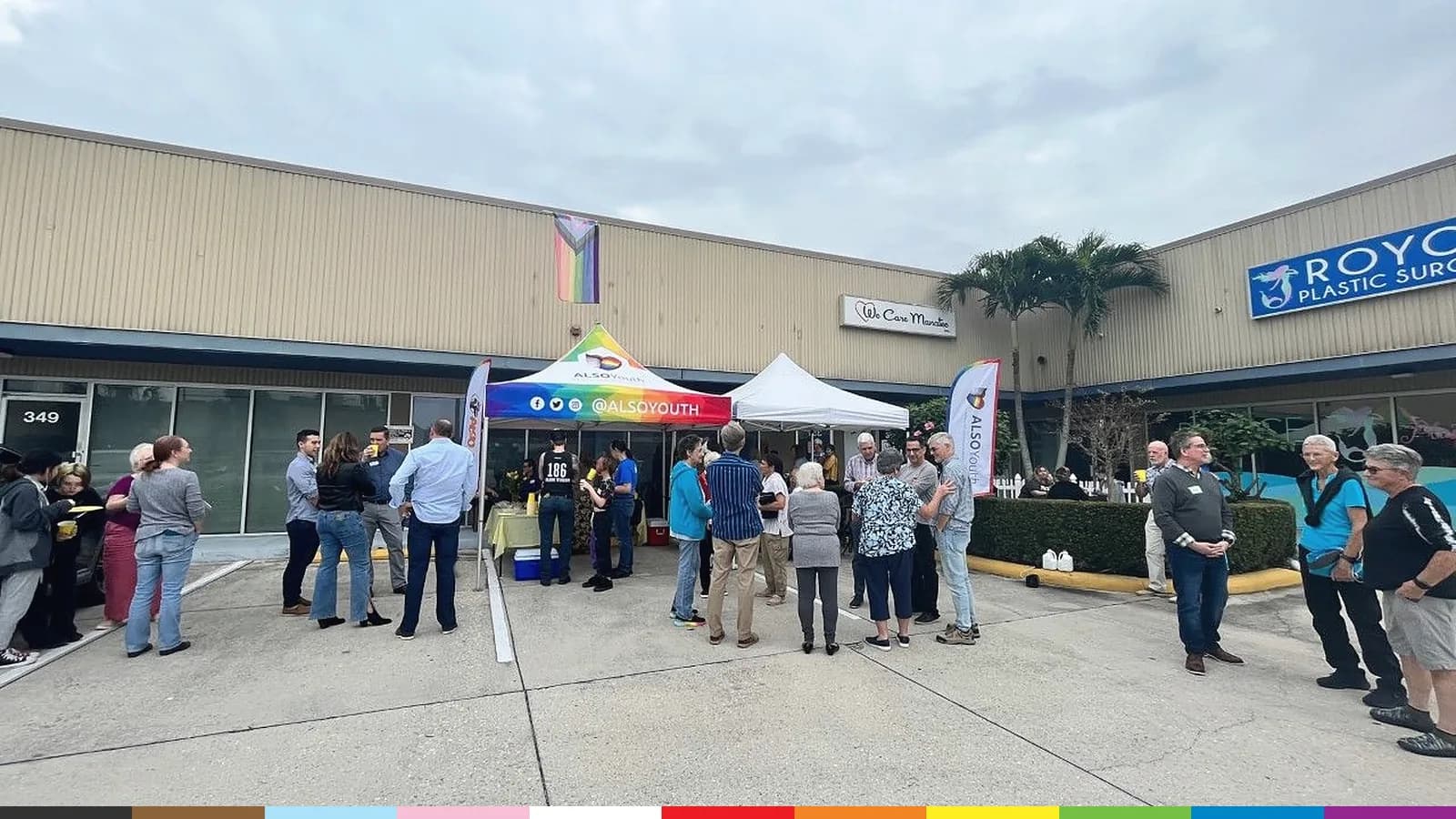 A crowd gathers under an ALSO Youth rainbow tent outside the Manatee Center at its opening celebration in 2022.