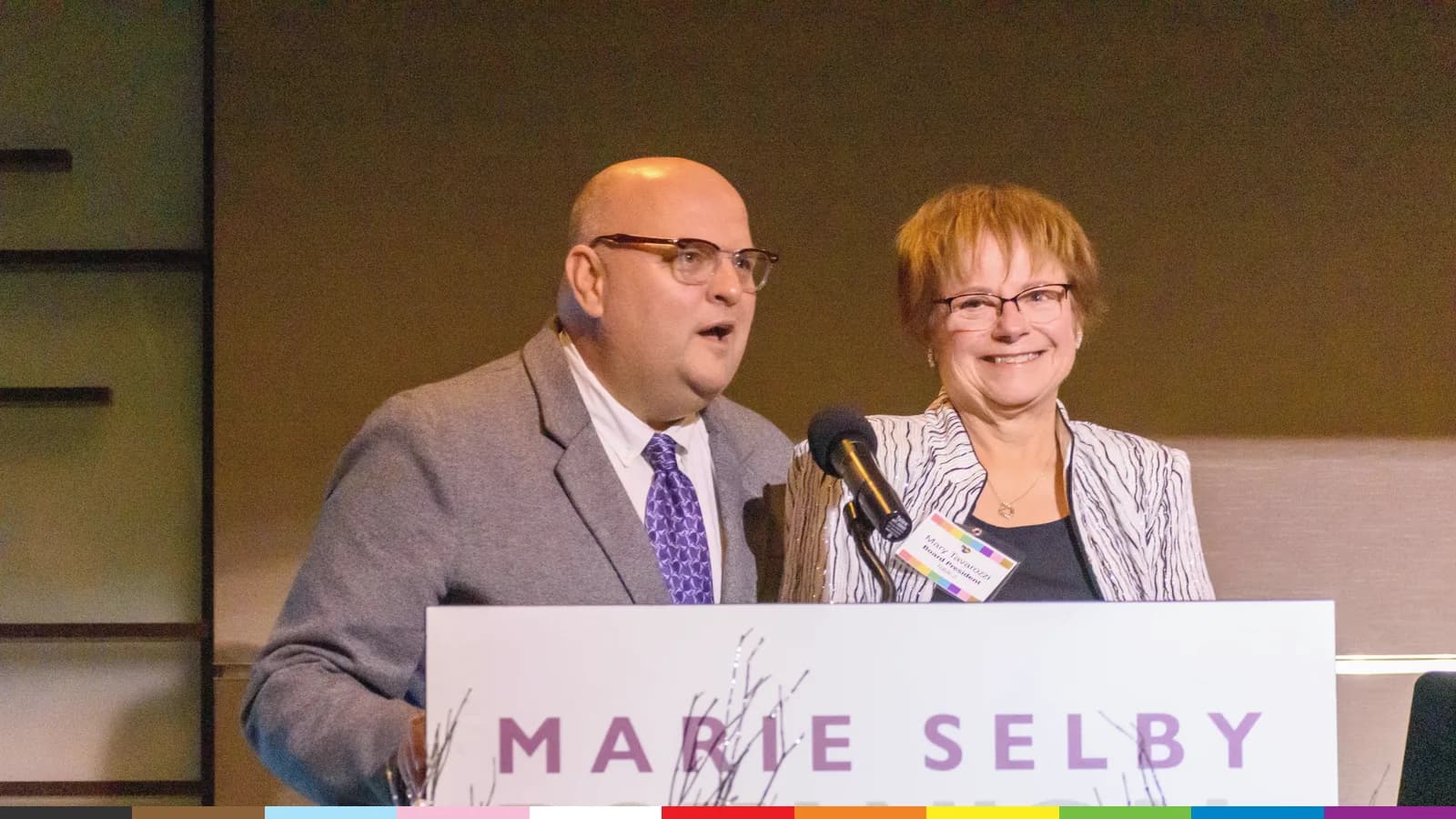 Two speakers share the Marie Selby Botanical Gardens podium at ALSO Youth's 30th anniversary gala in 2022.